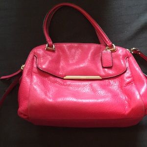 Pink all leather Coach bag with adjustable strap, multi compartments on inside.